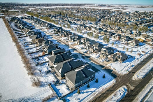 Drone capture of Evergreen, Saskatoon, highlighting its unique layout and lush green spaces.