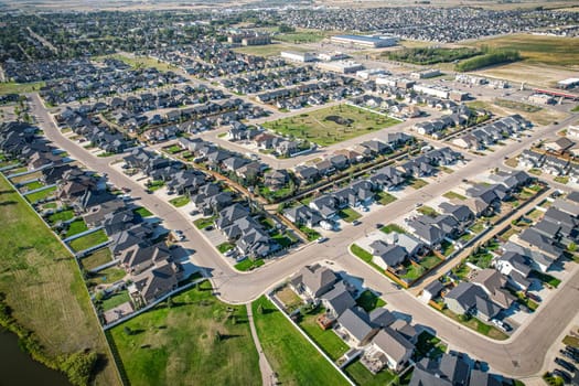 Drone image capturing the town of Warman in Saskatchewan during the summer season, highlighting its suburban and residential areas surrounded by lush greenery and vibrant atmosphere