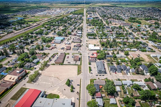 Drone image capturing the town of Warman in Saskatchewan during the summer season, highlighting its suburban and residential areas surrounded by lush greenery and vibrant atmosphere