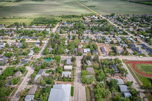 Drone image capturing the town of Dalmeny in Saskatchewan during the summer season, showcasing its vibrant greenery and serene atmosphere