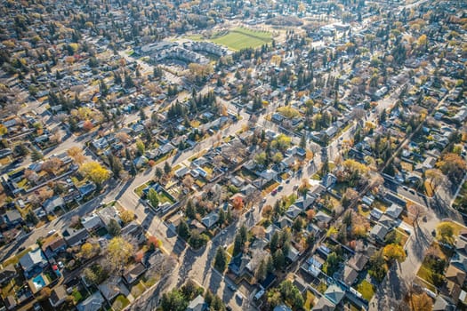 Drone image capturing the picturesque Queen Elizabeth neighborhood in Saskatoon, with its charming residential properties and colorful fall foliage