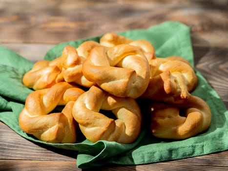 Taralli twist on wooden background. Typical italian ring-shaped or doughnut-shaped biscuit cookies or appetizers for wine Taralli or Taralle. Copy space
