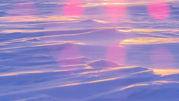 Winter snow hills in a field at sunset.