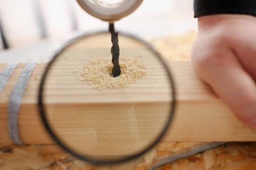 Flat drill bit make hole in wooden bar closeup. DIY job inspiration improvement fix shop powersaw bench joinery startup workplace idea career shaving industrial education concept