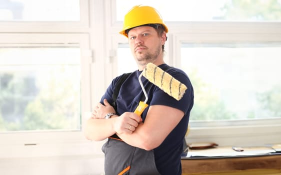 Smiling worker hold brush portrait. Manual job workplace DIY inspiration improvement fix shop yellow helmet hard hat joinery startup idea industrial education profession career concept