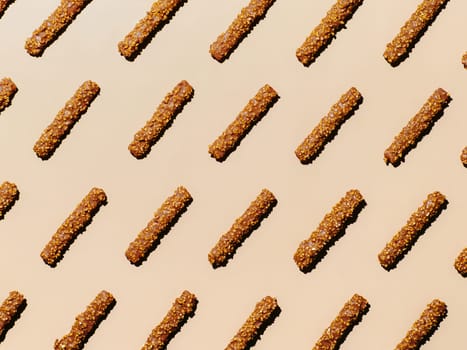 Chocolate candy with peanuts. Long sticks chocolate candy pattern on beige background. Sweet food pattern aesthetic. Food knolling