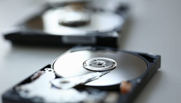 Hard drive from computer or laptop lies on the table in the repair shop. Performs fault diagnostics and performs urgent repairs recovery of lost data during deletion HDD closeup