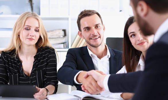 Smiling man in suit shake hands as hello in office portrait. Friend welcome mediation offer positive introduction greet or thanks gesture summit participate approval strike arm bargain concept