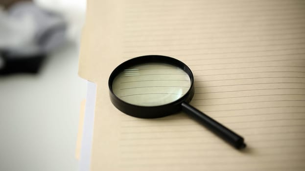 The black reading lens is on the yellow spreading insurance folder 404 error page not found closeup.