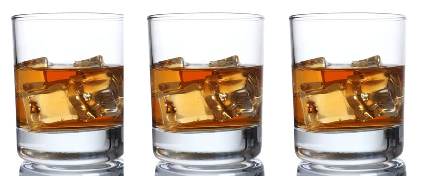 Whiskey with ice in a glass isolated on a white background