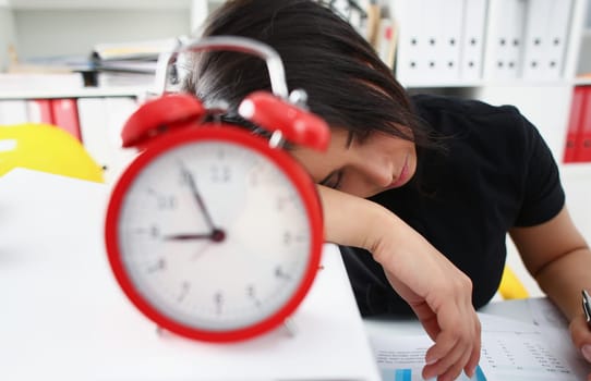 Tired and exhausted chinese woman have a lot of work with documents fall asleep. Huge pile of document folders, headache and depression concept