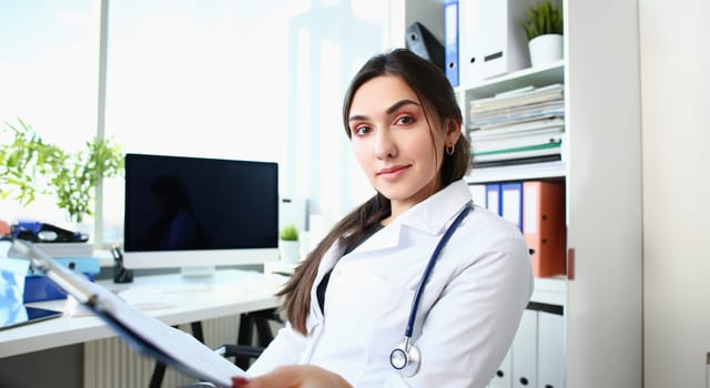 Beautiful smiling female doctor at workplace portrait. Physical and disease prevention patient aid exam visit 911 ward round prescribe remedy healthy lifestyle consultant profession concept