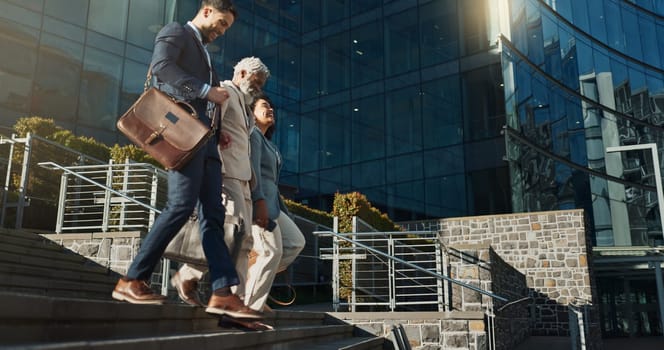 Business people, stairs and outdoor in city with conversation for travel, commute or walking to work. Employee, professional and colleague with briefcase, communication and happy on steps by building.