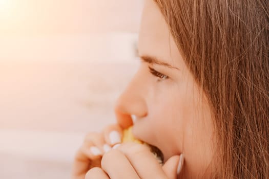 Healthy vegetarian hipster woman in summer outfit eat grilled corn and look to camera. Sexy lady on sea beach sunset or ocean sunrise. Travel, explore, active yoga and meditation lifestyle concept.