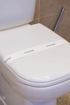 Ceramic toilet bowl with paper line hygiene text