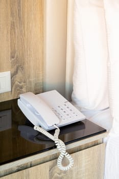 bedroom with telephone in front and bed in the background, focus on the telephone,for room service,communication