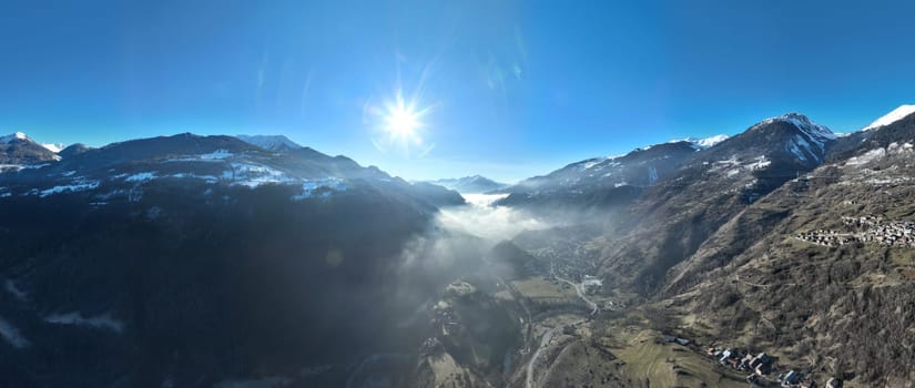 Winter drone shot of ski pistes and slopes covered with fresh powder snow in Tignes in Valdisere France. Alps aerial panoramic view on a beautiful sunny day ski lift snowboarding and skiing in resort