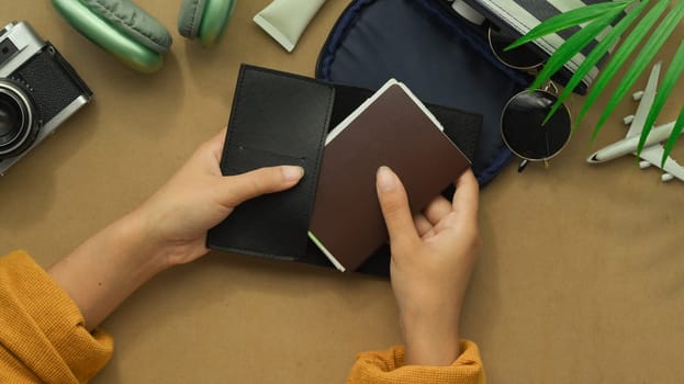 Above view hands holding passport. Ready to Travel, vacation and journey concept