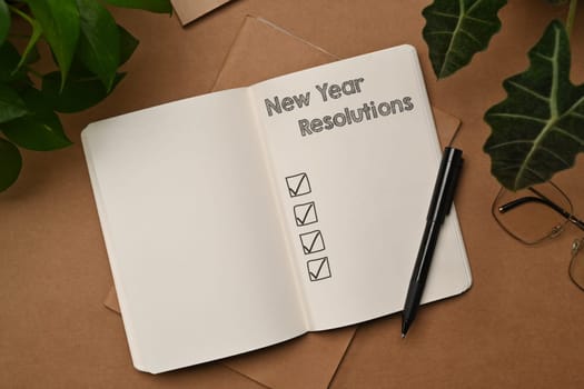 2024 New Year resolutions with list on notebook. Self improvement and development concept.