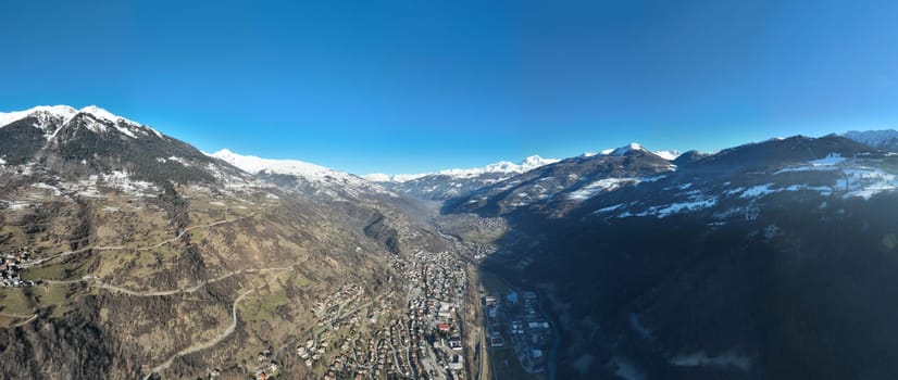 Winter drone shot of ski pistes and slopes covered with fresh powder snow in Tignes in Valdisere France. Alps aerial panoramic view on a beautiful sunny day ski lift snowboarding and skiing in resort