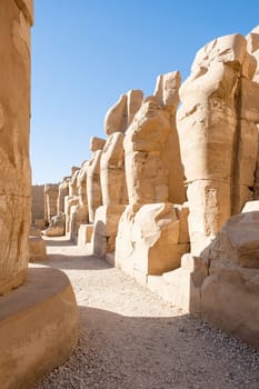the ruins of the ancient Karnak temple in the city of Luxor in Egypt. Great row of columns with carved hieroglyph