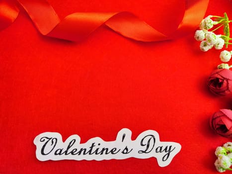 Valentine's Day concept celebration, congratulation. Red greeting Card with flower, Satin ribbon for Background, texture, place for text, copy space