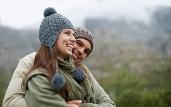 Couple, hug and happy on hiking vacation in outdoors, love and bonding in relationship for connection. People, embrace and travel for exploring adventure, romance and security in marriage on mountain.