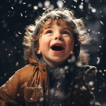 Cute little boy, look up at the falling flakes of snow, raising head up. Evening, magical atmosphere of Christmas Eve