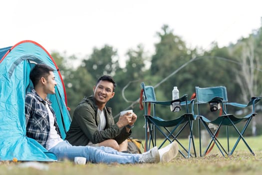 Happy Asian male gay couple on camping together in a forest. romantic vocation trip. lgbt concept.