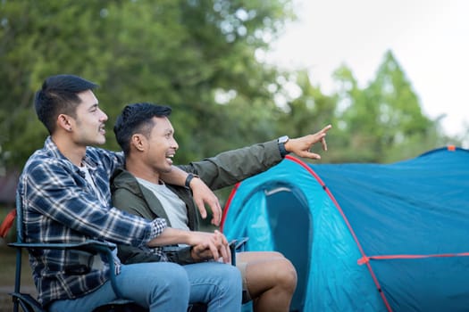 Happy Asian male gay couple on camping together in a forest. romantic vocation trip. lgbt concept.