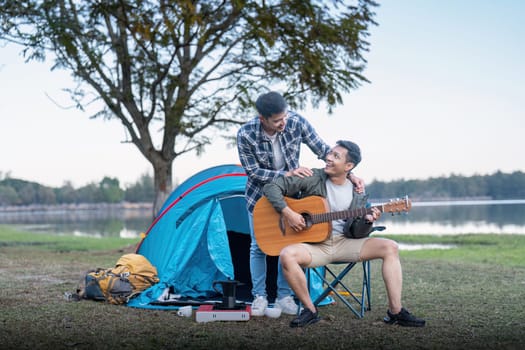 Happy Asian male gay couple on camping together in a forest. romantic vocation trip. lgbt concept.