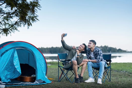 Happy Asian male gay couple on camping together in a forest. romantic vocation trip. lgbt concept.