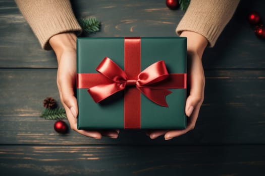 Hands holding dark green gift box and red ribbon top view, Christmas concept. Generative AI.