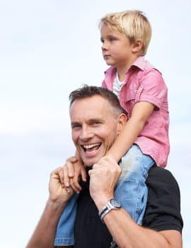 Love, portrait and piggyback by father and son outdoor for fun, bonding or travel adventure. Happy family, support or parent with boy kid outside for shoulder ride, games or care, security or journey.