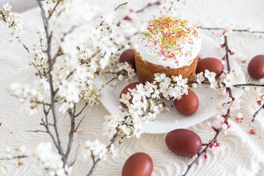 Traditional Easter cakes and colored eggs. A branch tree.