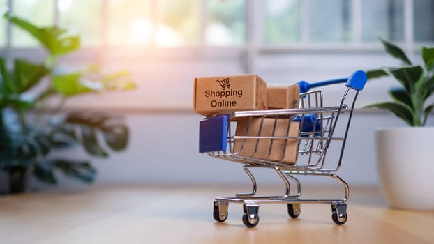 Online shopping, Product package boxes in cart with shopping bag  delivery concept, Shopping service on The online web and offers home delivery, online shopping and delivery concept.