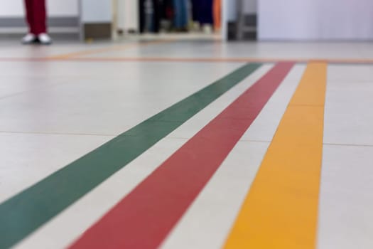 Colorful guidance lines on a hospital corridor floor for navigation