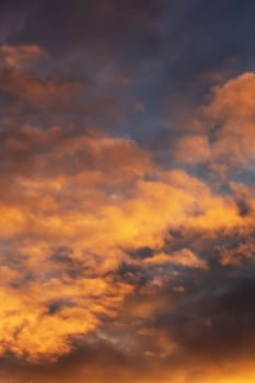 Bright yellow clouds at sunset in sky close up