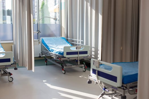 Moscow, Moscow region, Russia - 03.09.2023:Modern hospital room with unoccupied beds and sunlit curtains