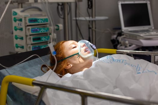 Moscow, Moscow region, Russia - 03.09.2023:Educational realistic medical mannequin of a woman lying on a hospital bed undergoing oxygen therapy, with medical equipment in the background