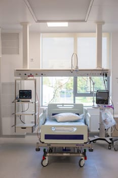 Moscow, Moscow region, Russia - 03.09.2023:A well-equipped hospital room with an empty bed, medical monitors, and various devices.