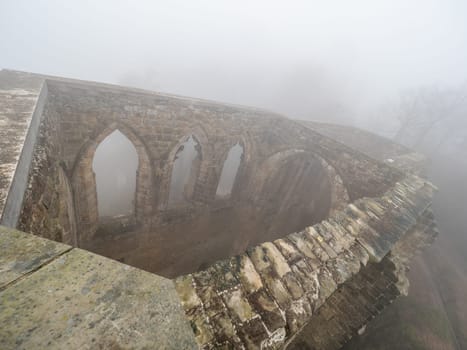 The ruins of Oybin in the mist.. The temple and burg  founded as Celestines monastery in 1369 in the Zittau Mountains on the border of Germany Saxony with the Czech Republic