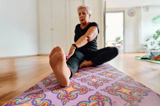 An elderly woman gracefully engages in various yoga poses, stretching her limbs and finding serenity in a modern sunlit space under the guidance of a trained instructor, embodying the essence of active and mindful aging.