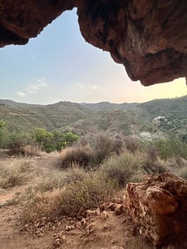 A view from inside of a cave in the mountains. High quality photo