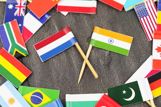 Policy. National flags of different countries. The concept is diplomacy. In the middle among the various flags are two flags - India, Netherlands