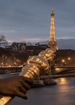 France, Paris - Jan 4, 2024 - Nice scenery of Golden statue adorning Pont Alexandre III Bridge over the Seine River and Eiffel Tower in Paris at sunset. Destinations in Europe. Space for text, Selective focus.