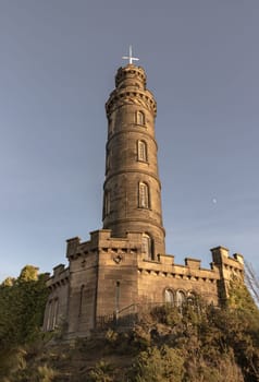 Edinburgh, Scotland - Jan 18, 2024 - Bottom-up view of Nelson's Monument with a bright blue sky in the background. Architecture design of Tower situated on Calton Hill at Edinburgh, Scotland, Space for text, Selective focus.