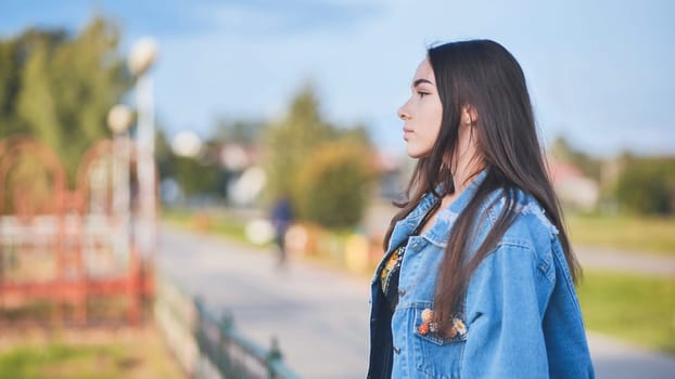 Portrait of a lonely girl by a lake