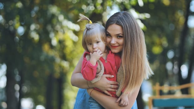 A happy mother with her young daughter in the park