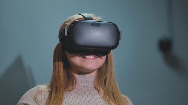 The girl plays virtual reality games in the club